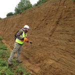 A geoscientist from Halliburton examines the Red Gravels during a joint trip with OGT on 17th Sept 2017