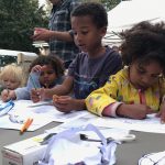 Young visitors colouring dinosaur pictures